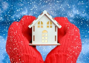 small cardboard house covered in snow